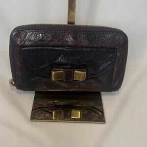 Chloe Lilly bow front long wallet in a metallic maroon brown